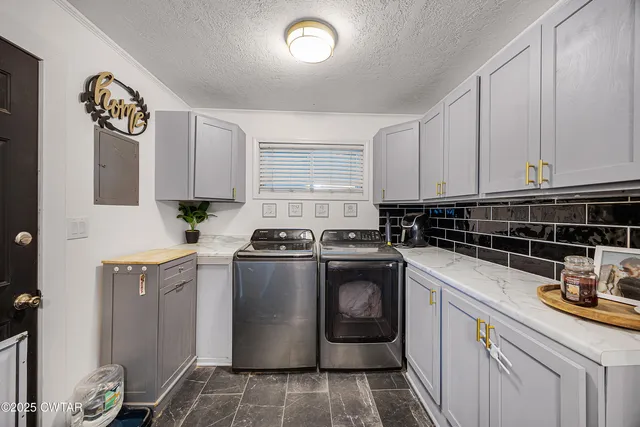 a kitchen with granite countertop a sink a stove and cabinets