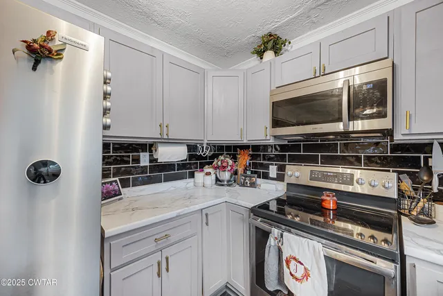 a kitchen with a stove a sink and a microwave