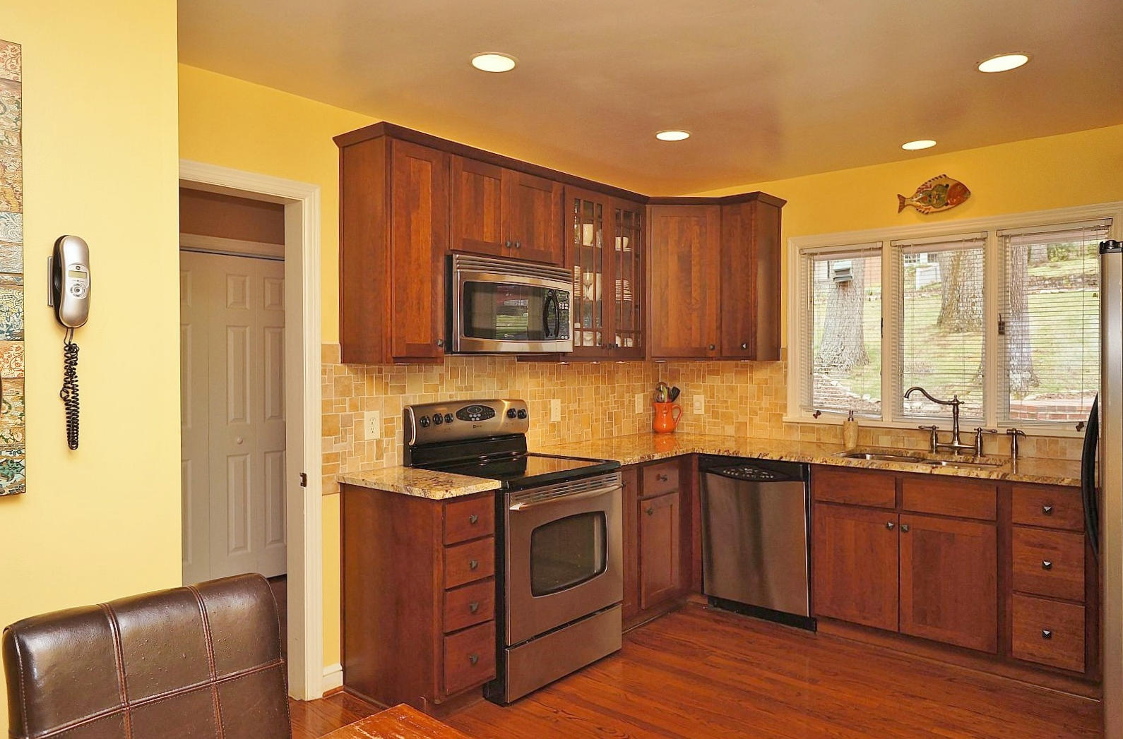 3113 Stoneridge Road Southwest Roanoke, VA 24014 - Photo 11 of 42 a kitchen with stainless steel appliances granite countertop wooden cabinets a stove a sink and a microwave