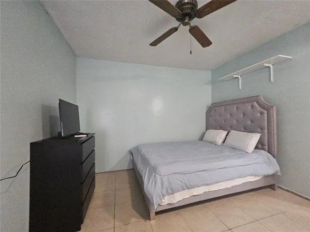 a bedroom with a bed and a television