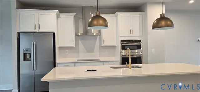 a kitchen with a sink a refrigerator and a stove