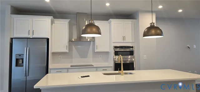 a kitchen with a sink a counter space and stainless steel appliances