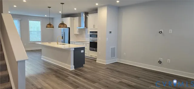 a large kitchen with a sink and a large window