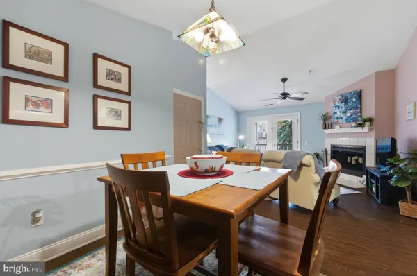 a view of a dining room with furniture wooden floor and chandelier
