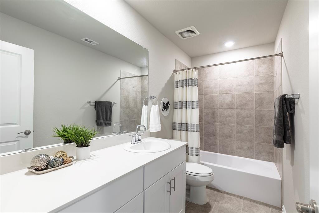 1504 Cobblestone Road Melissa, TX 75454 - Photo 28 of 39 Well-appointed full bath with extended vanity and tiled shower surround.