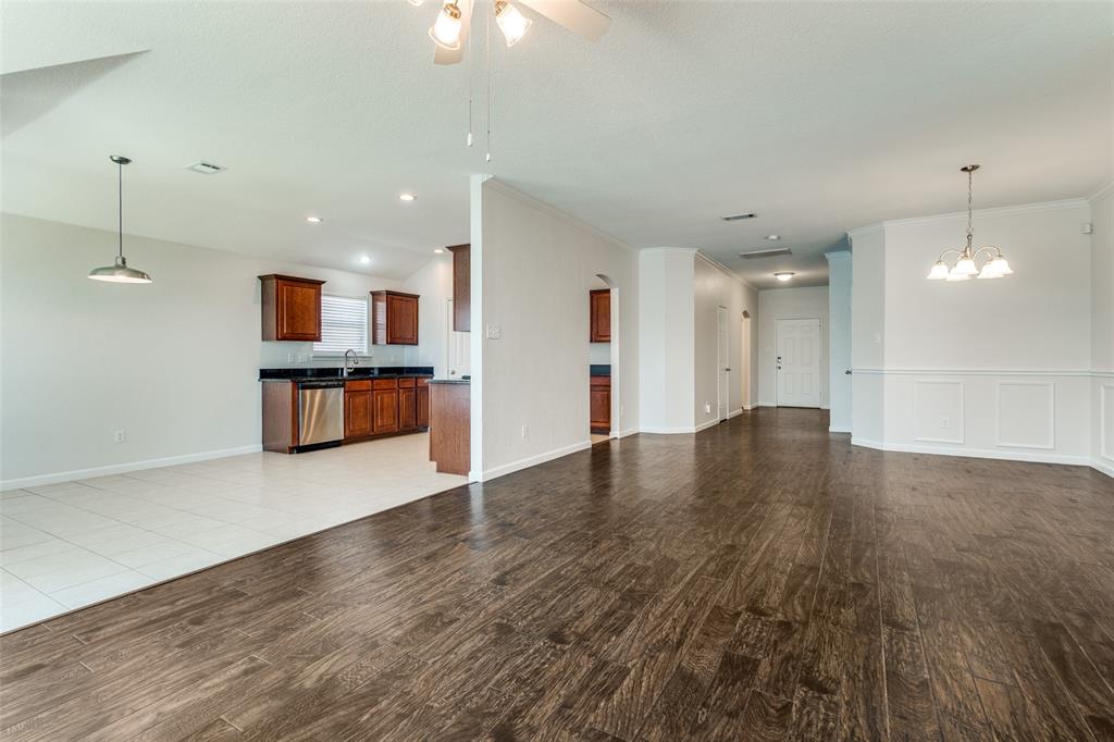 1257 Barrel Run Fort Worth, TX 76052 - Photo 8 of 26 Open-concept living area featuring wood-finish flooring, white wall paneling.