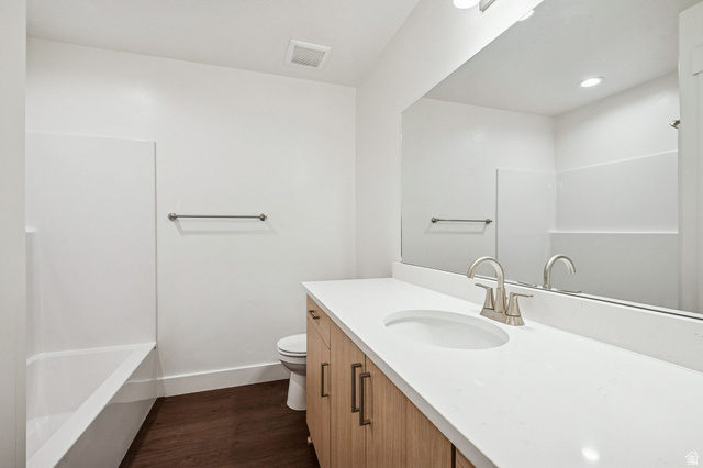 1627 North Angel Street Layton, UT 84041 - Photo 9 of 39 Full bathroom featuring vanity, dark wood-style floors, and shower / tub combination