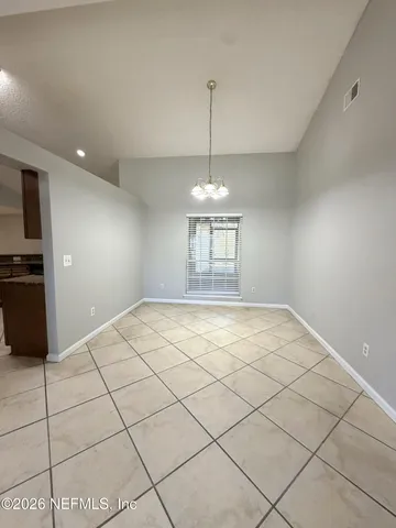 a view of an empty room and a window