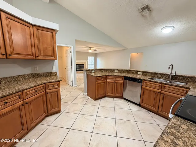 a kitchen with stainless steel appliances granite countertop a sink and cabinets