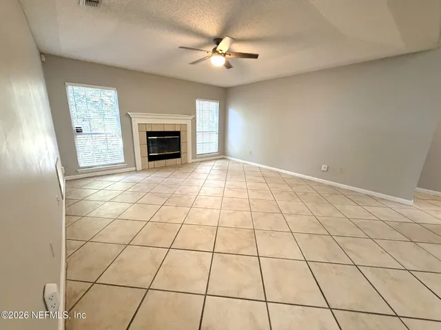 a view of an empty room with a fireplace