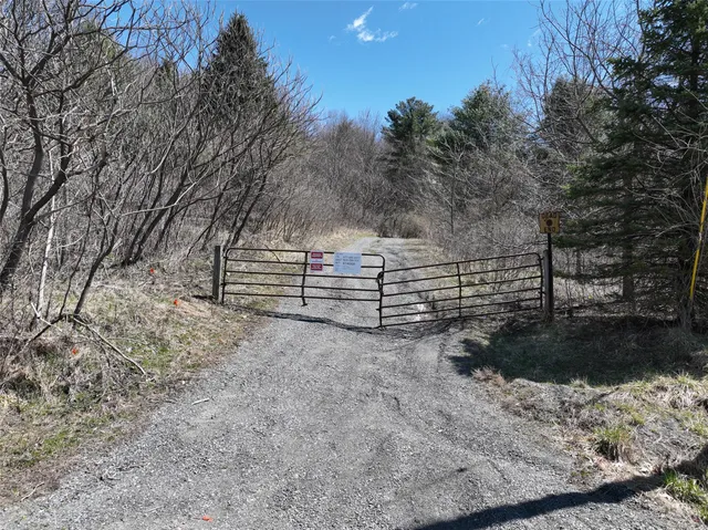 a view of a yard with wooden fence