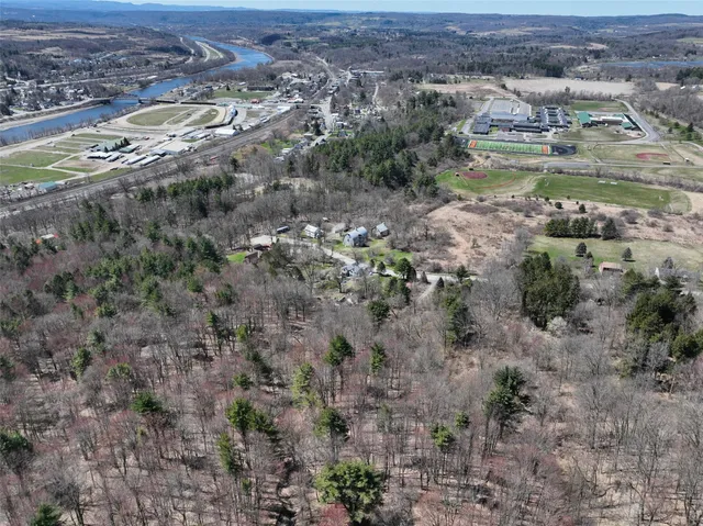 an aerial view of a houses with a yard