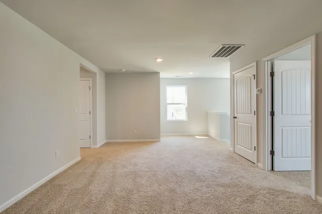a view of an empty room and a window