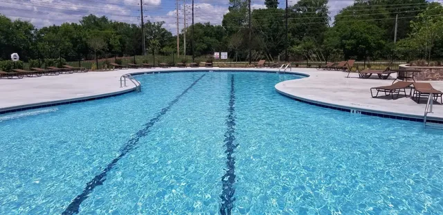 a view of a swimming pool with chairs
