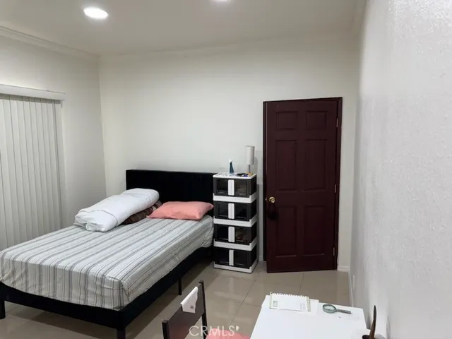 a bedroom with a bed and a dresser