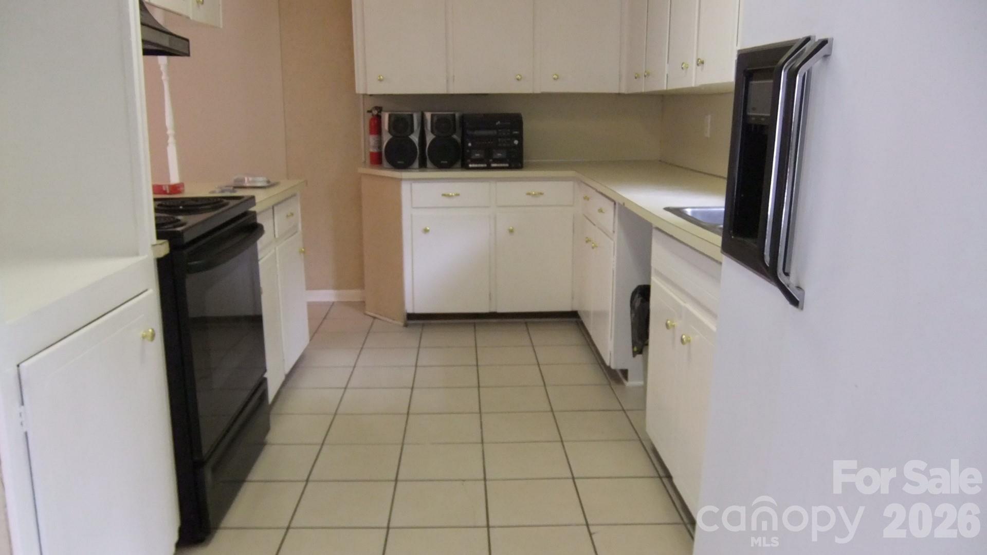 1631 Harris Road Fort Mill, SC 29708 - Photo 16 of 31 a kitchen with a refrigerator a stove top oven and cabinets