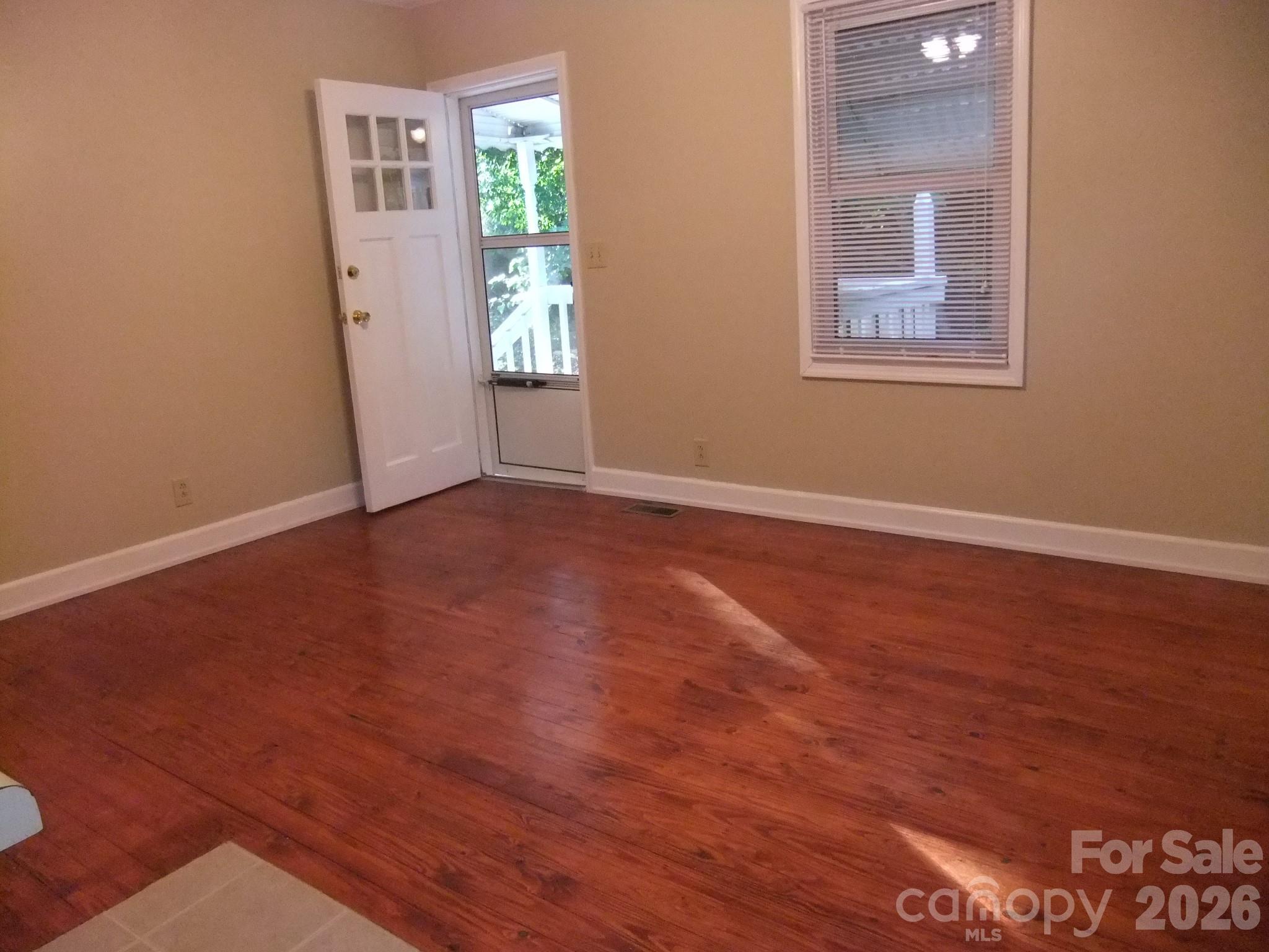 1631 Harris Road Fort Mill, SC 29708 - Photo 8 of 31 an empty room with wooden floor and windows