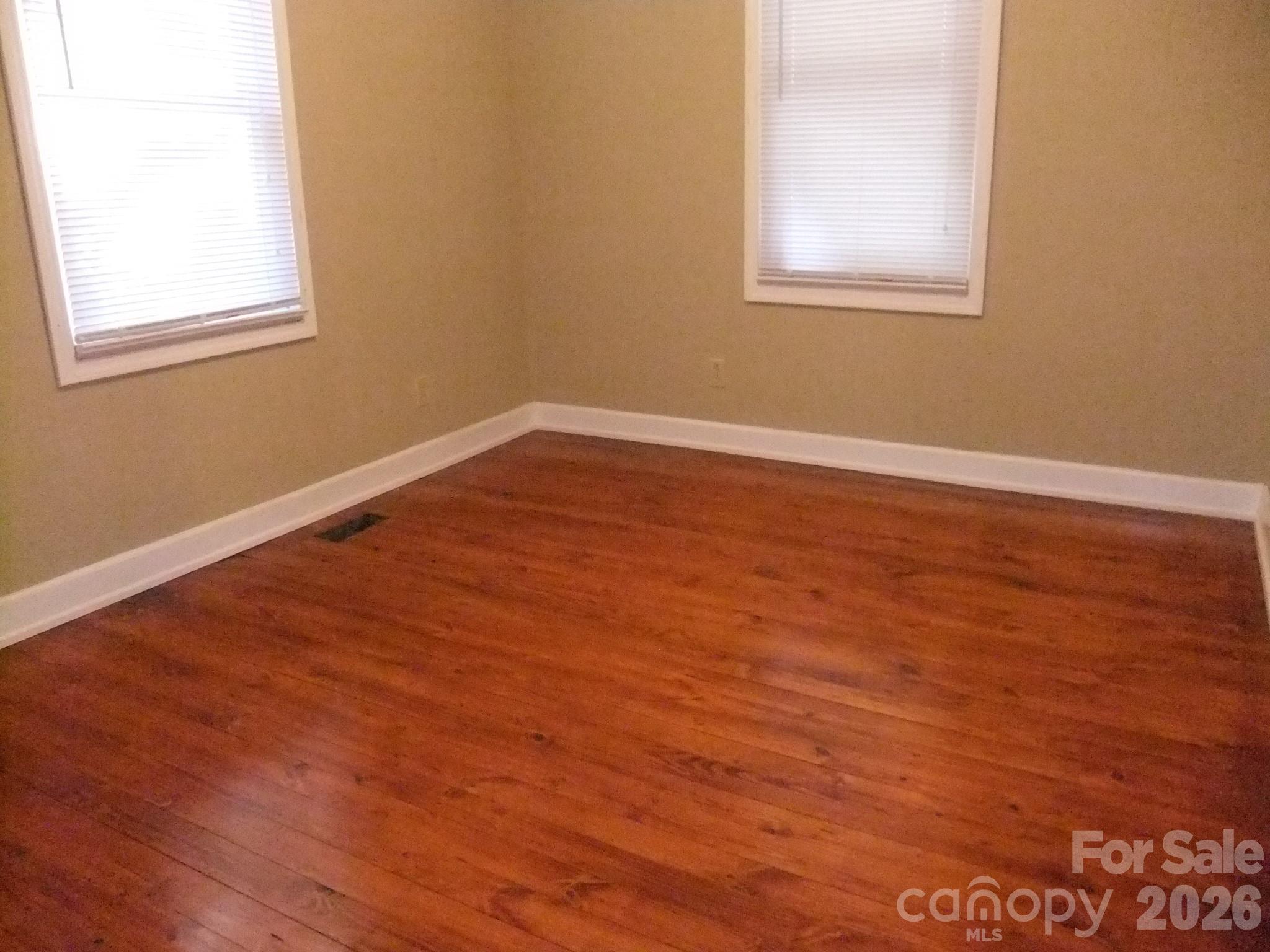1631 Harris Road Fort Mill, SC 29708 - Photo 9 of 31 an empty room with wooden floor and windows