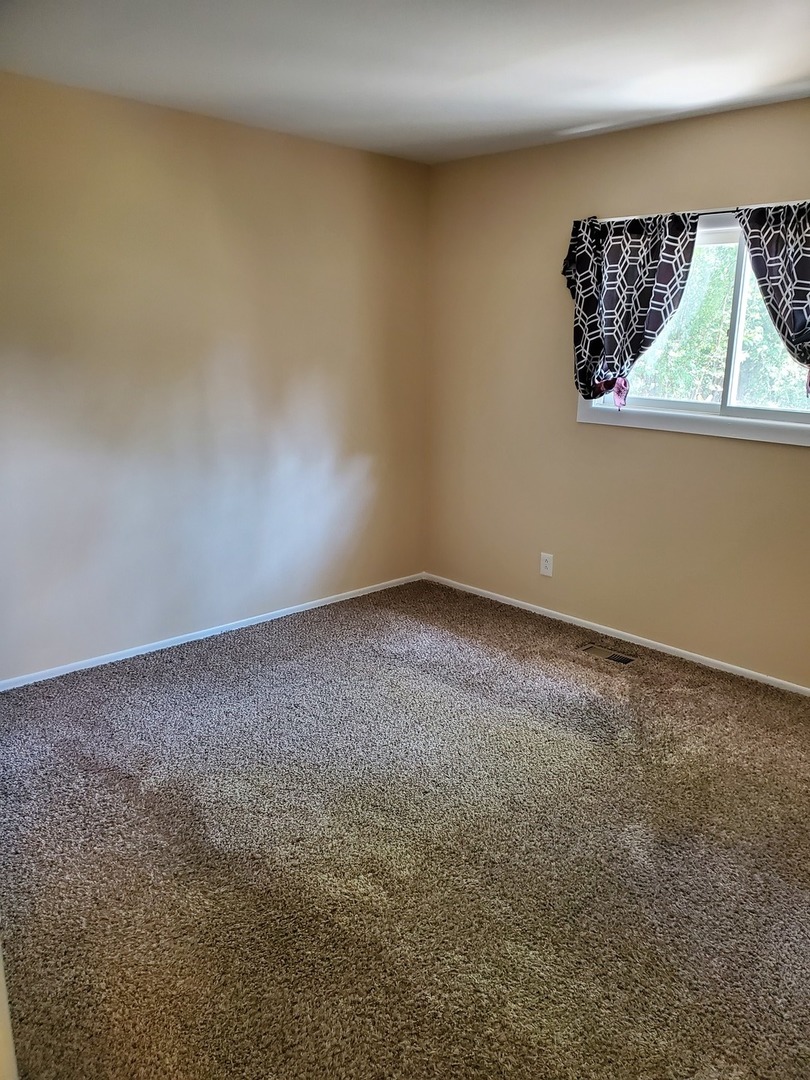 152 Bedford Road Bolingbrook, IL 60440 - Photo 2 of 12 an empty room with a window