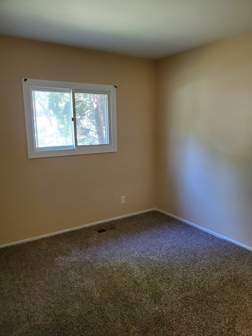 152 Bedford Road Bolingbrook, IL 60440 - Photo 3 of 12 an empty room with a window
