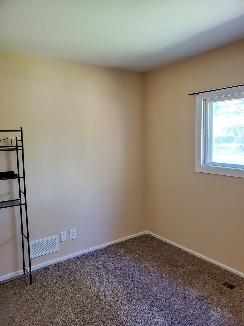 152 Bedford Road Bolingbrook, IL 60440 - Photo 4 of 12 an empty room with a empty space and windows
