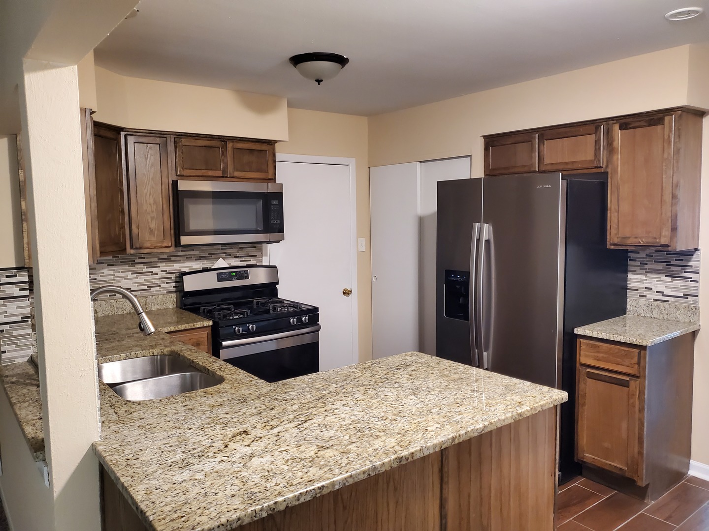 152 Bedford Road Bolingbrook, IL 60440 - Photo 6 of 12 a kitchen with a appliances wooden cabinets and a counter top space