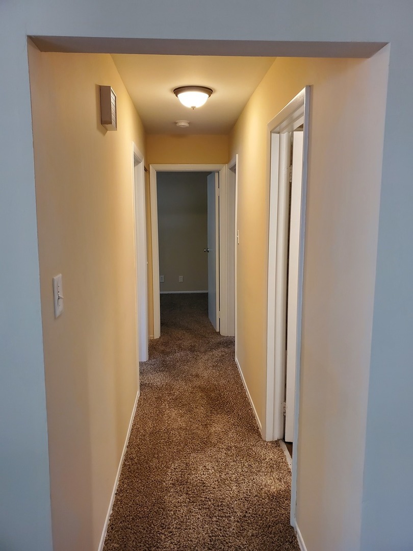 152 Bedford Road Bolingbrook, IL 60440 - Photo 8 of 12 a view of a hallway with wooden floor