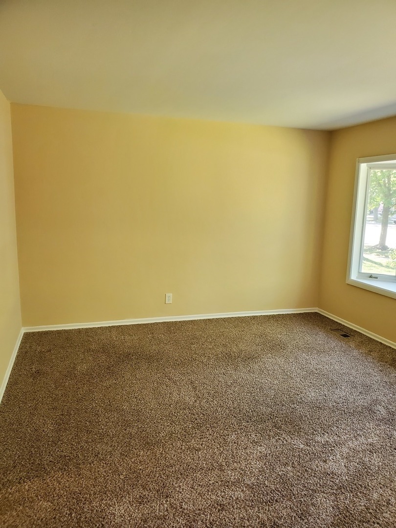 152 Bedford Road Bolingbrook, IL 60440 - Photo 9 of 12 a view of an empty room and window