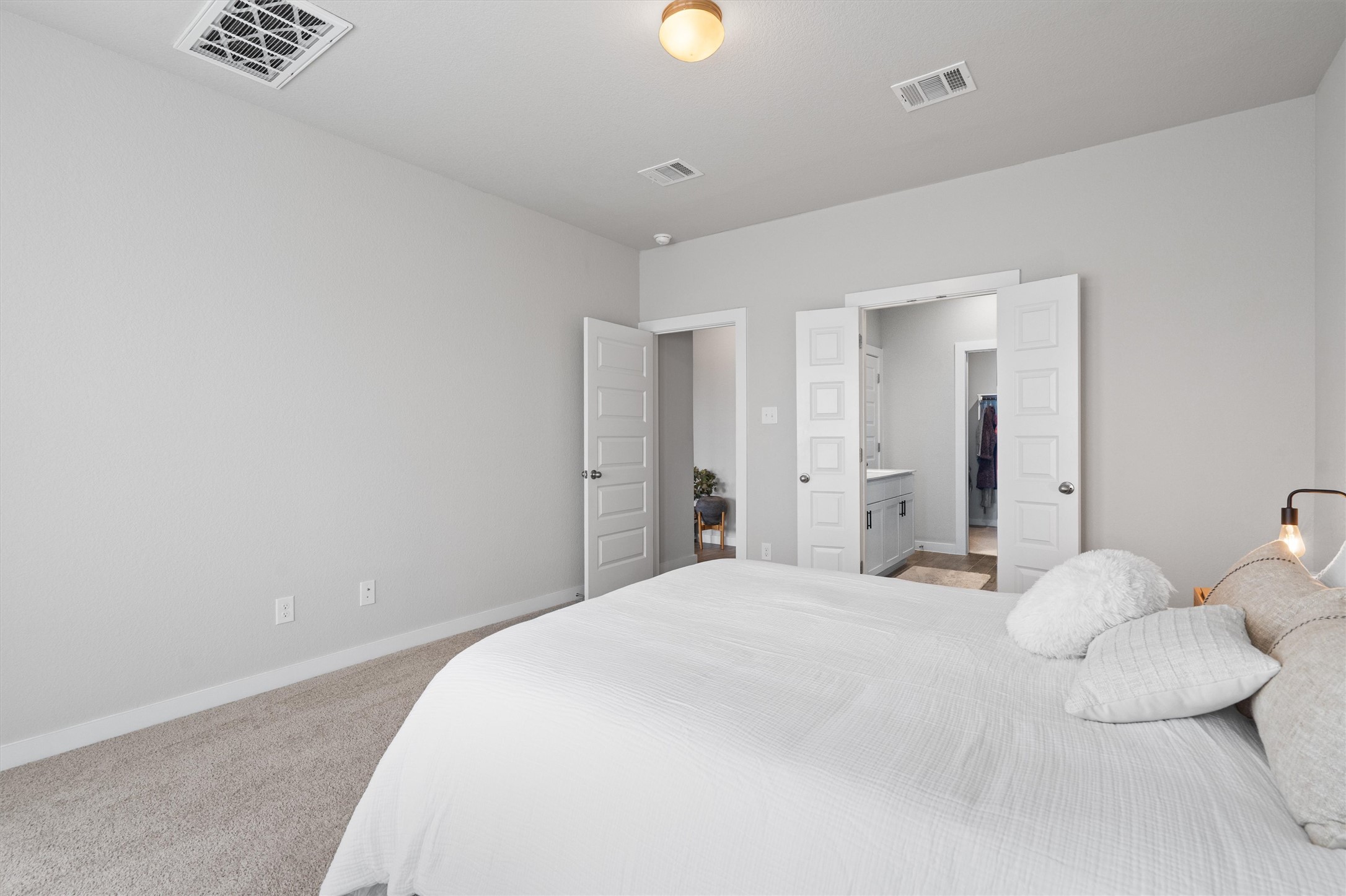 11620 Comano Drive Austin, TX 78747 - Photo 17 of 34 Bedroom featuring light grey walls, carpeted flooring, and a ceiling light fixture