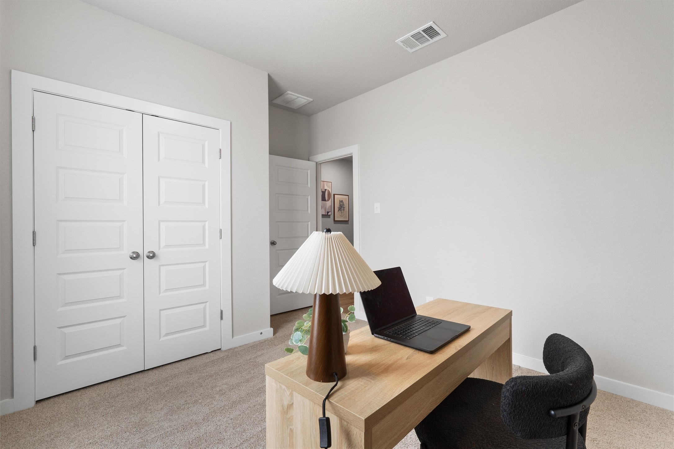 11620 Comano Drive Austin, TX 78747 - Photo 23 of 34 This room features light grey walls, light-colored carpet, and white bi-fold doors