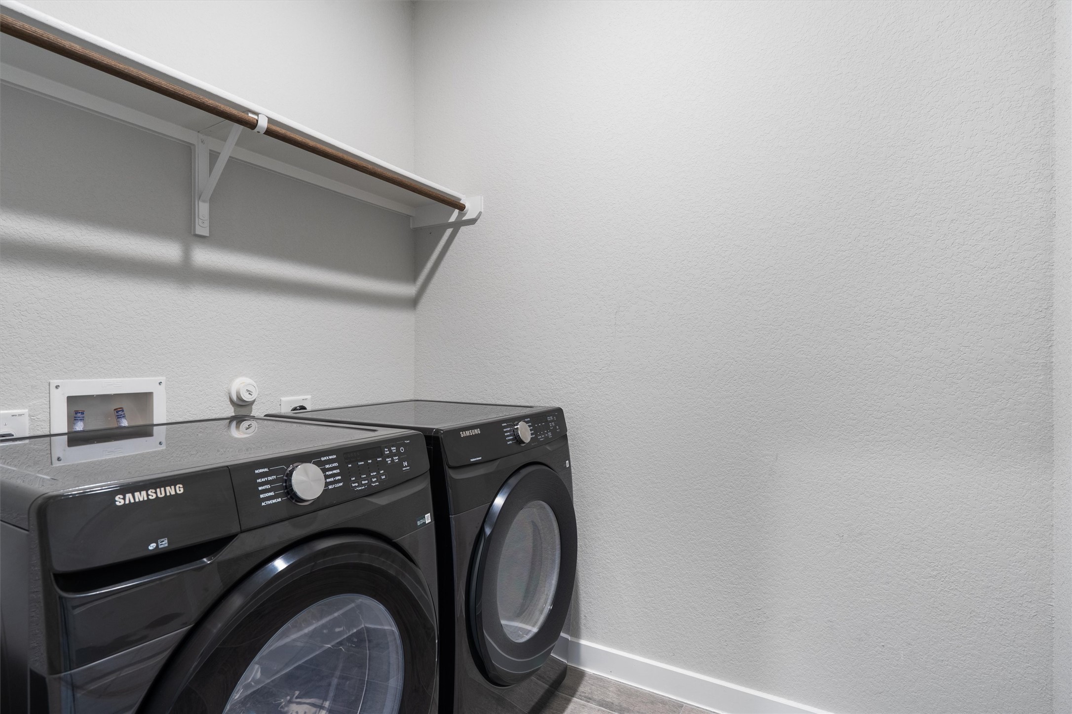 11620 Comano Drive Austin, TX 78747 - Photo 28 of 34 The laundry area features a clothes rod and a washer and dryer