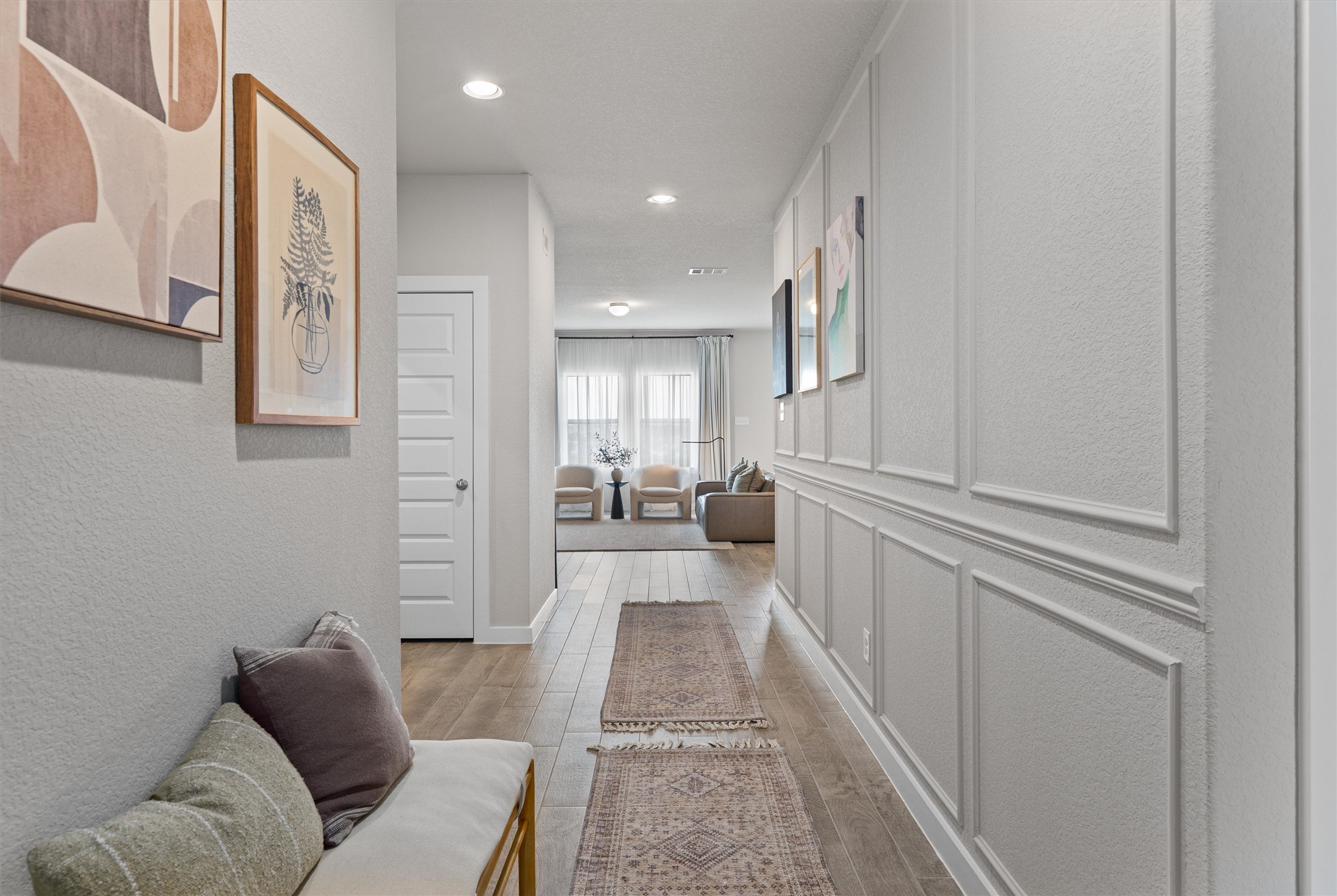 11620 Comano Drive Austin, TX 78747 - Photo 3 of 34 The property features a hallway with light-colored flooring and stylish wall paneling