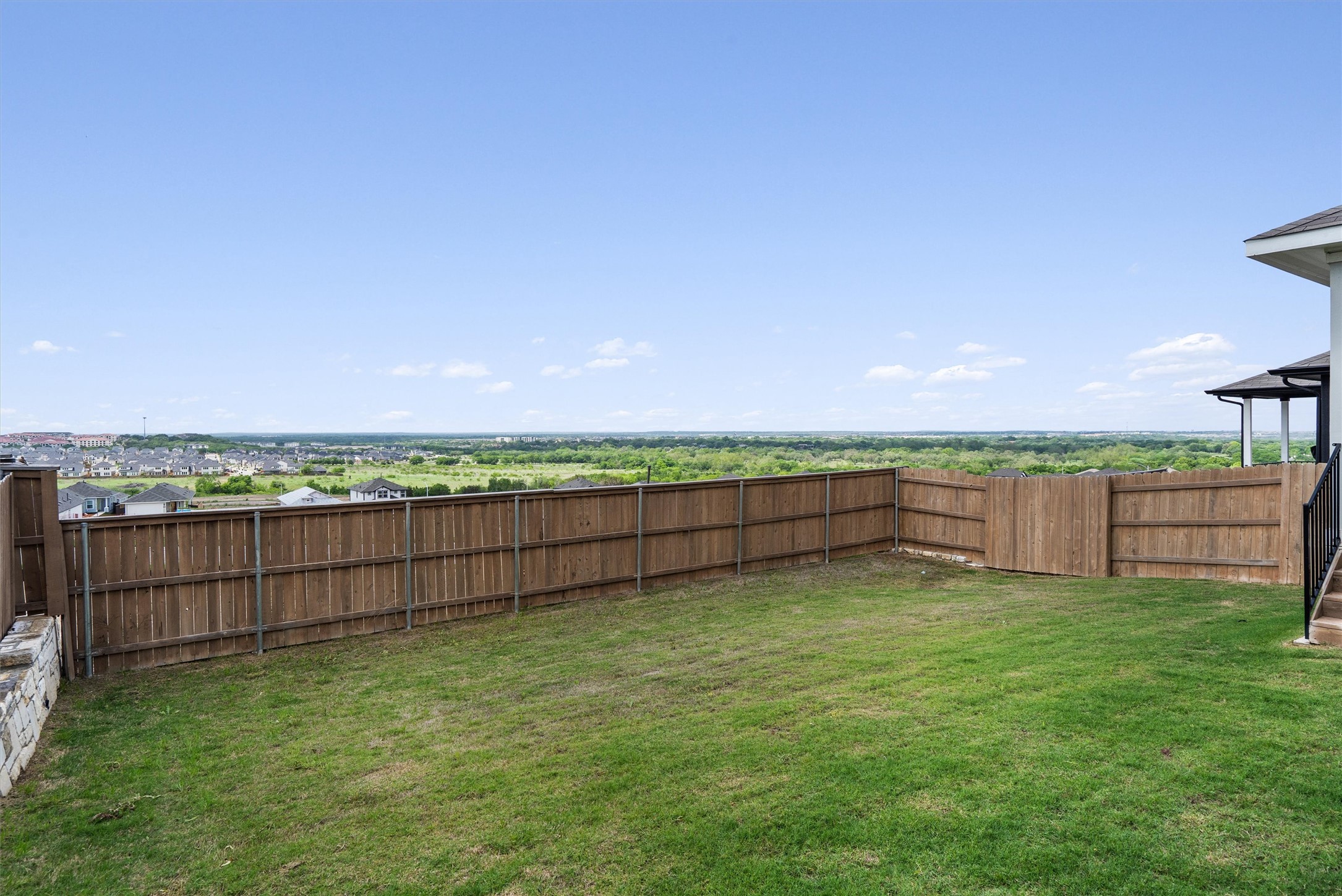 11620 Comano Drive Austin, TX 78747 - Photo 32 of 34 The property includes a spacious backyard with a wooden fence and a grassy lawn