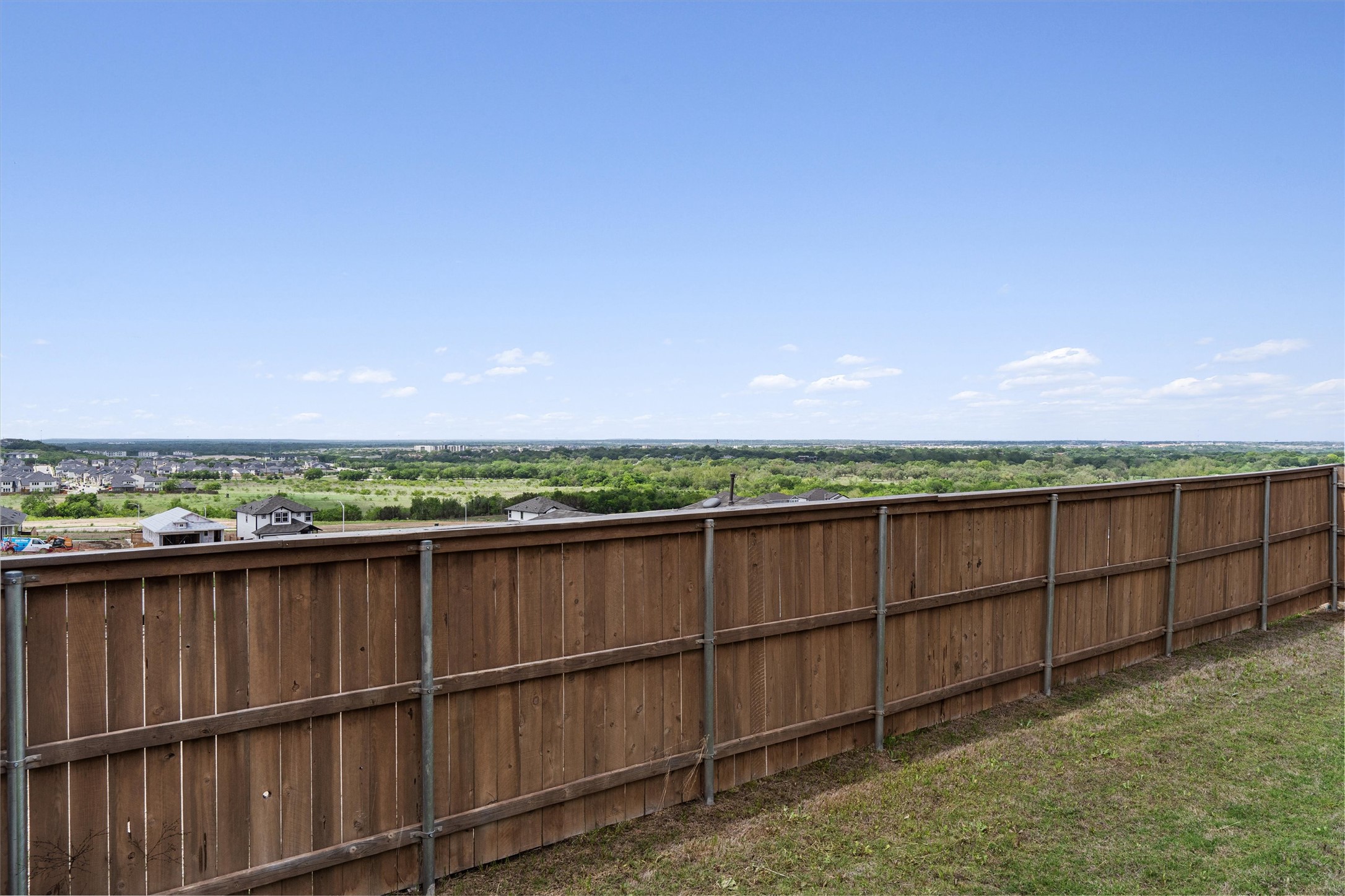 11620 Comano Drive Austin, TX 78747 - Photo 33 of 34 The property features a wood fence with metal posts and a grassy area