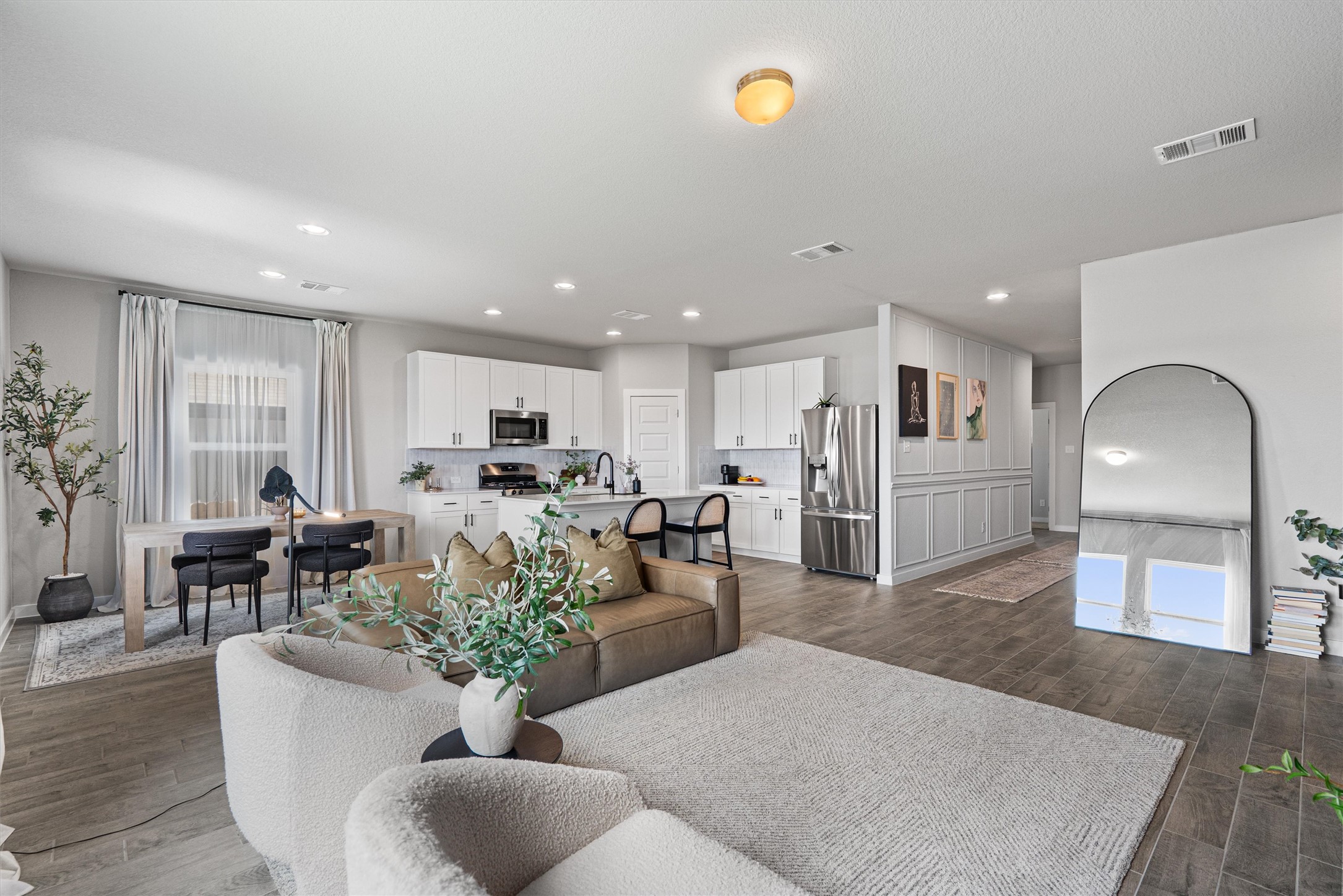 11620 Comano Drive Austin, TX 78747 - Photo 7 of 34 Spacious open-concept interior featuring light-colored walls, recessed lighting, and wood-look flooring