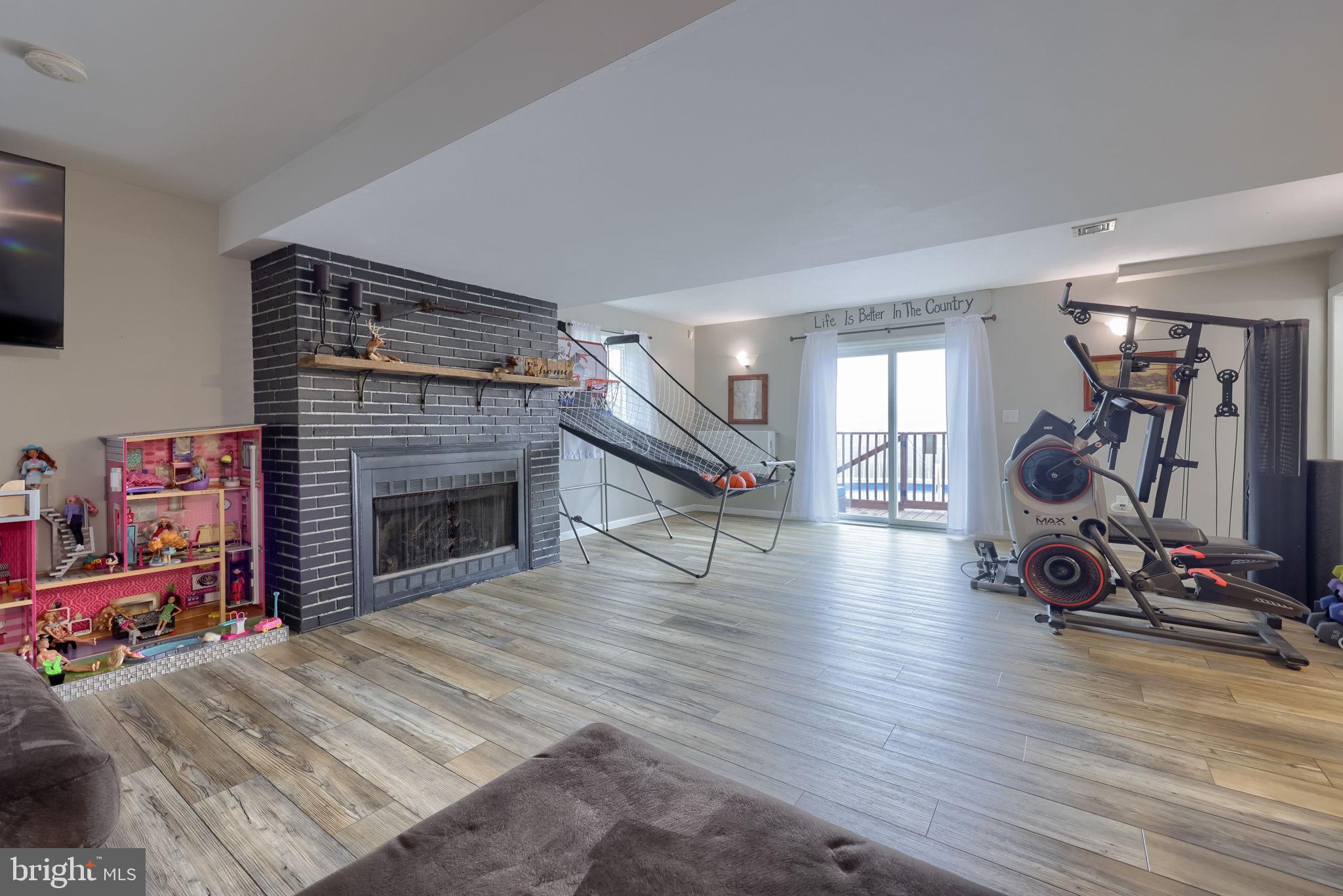 479 Hilldale Road Holtwood, PA 17532 - Photo 16 of 51 a room with wooden floor and a fireplace