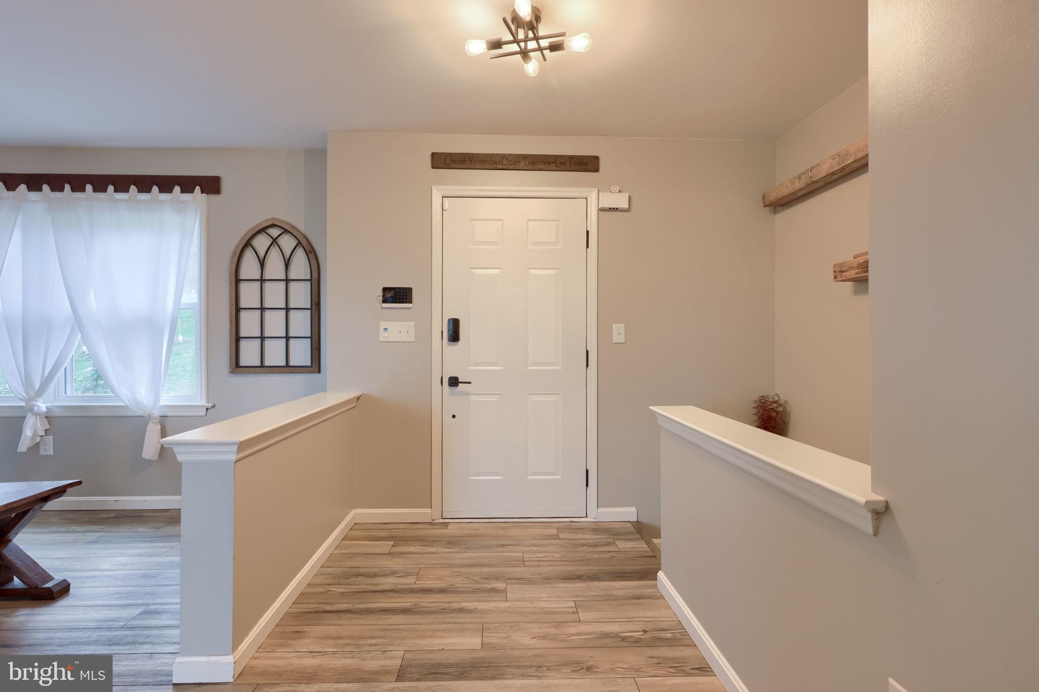 479 Hilldale Road Holtwood, PA 17532 - Photo 3 of 51 a view of a hallway to a livingroom with wooden floor and a window