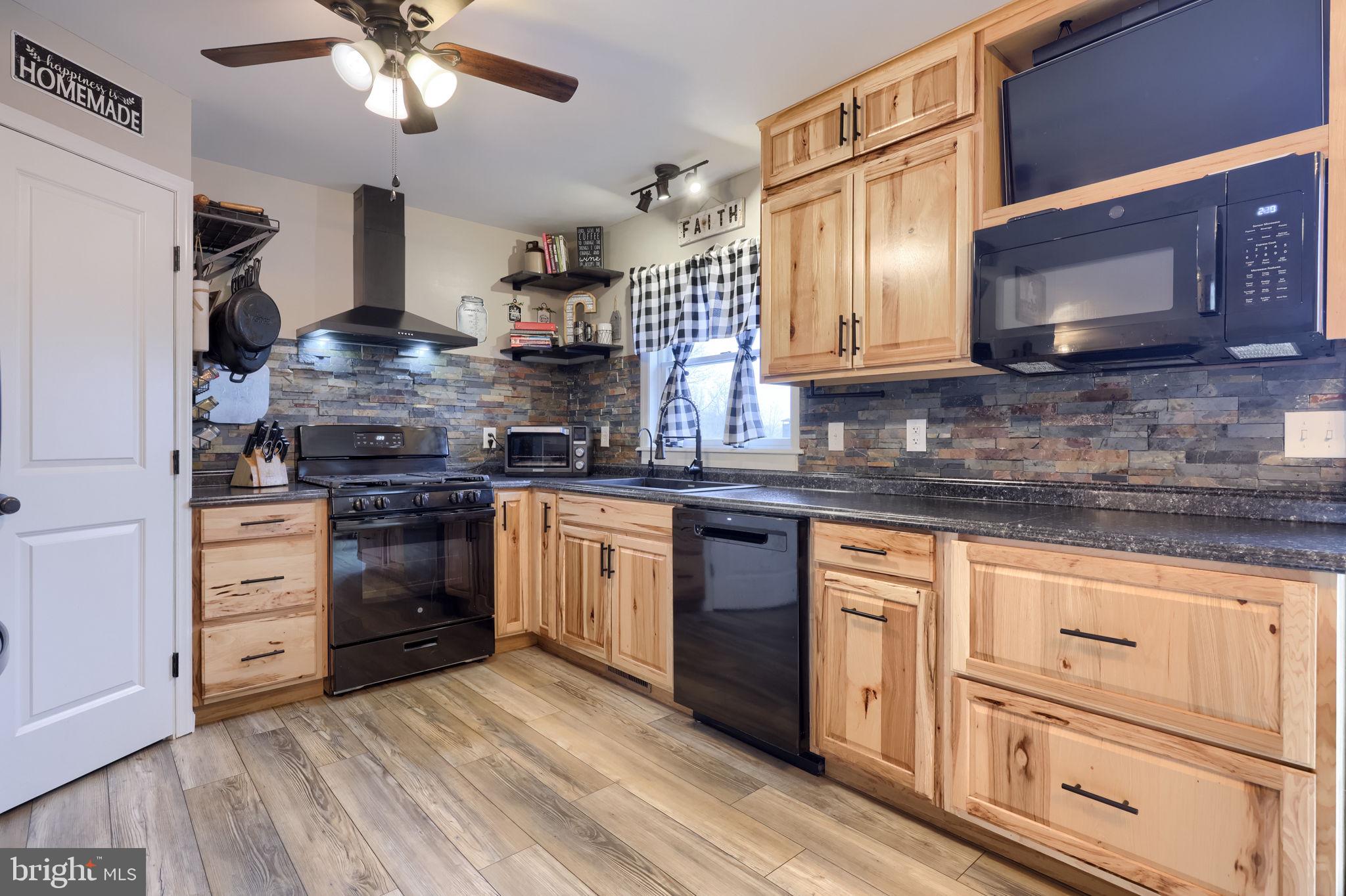 479 Hilldale Road Holtwood, PA 17532 - Photo 6 of 51 a kitchen with stainless steel appliances granite countertop a stove and a sink