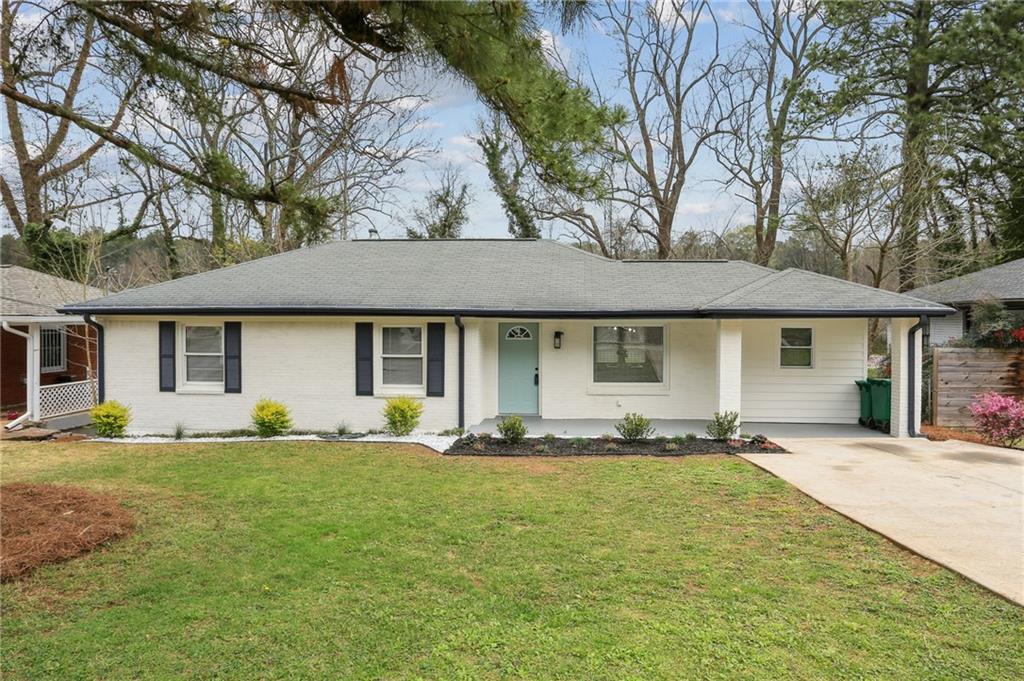 1780 Valencia Road Decatur, GA 30032 - Photo 1 of 1 a front view of a house with a yard and sitting area