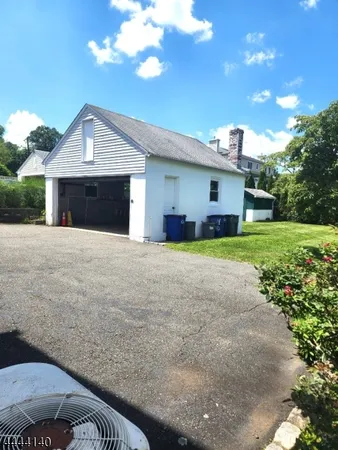 a view of a house with a yard and garage