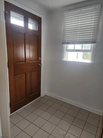 an empty room that has a window in it