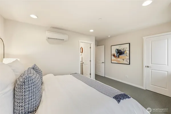 a bedroom with a large bed and a chandelier