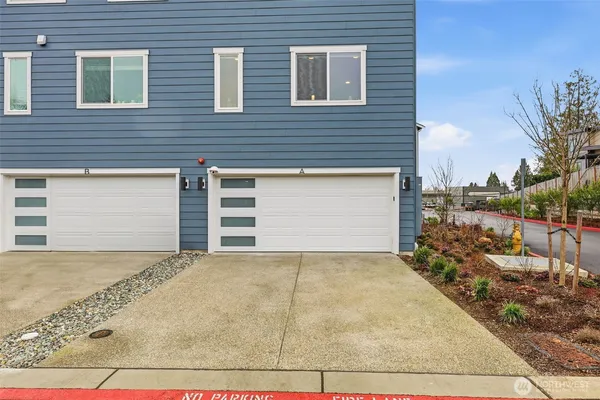 a view of backyard of house and car parked