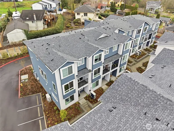 an aerial view of a house with a yard