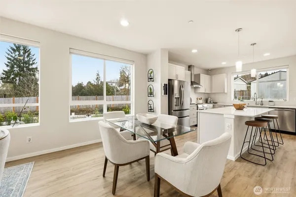 a dining room with furniture and a large window