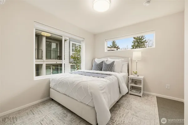 a bedroom with a bed and a large window