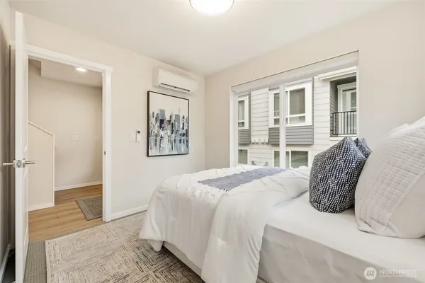 a bedroom with a bed and a large window