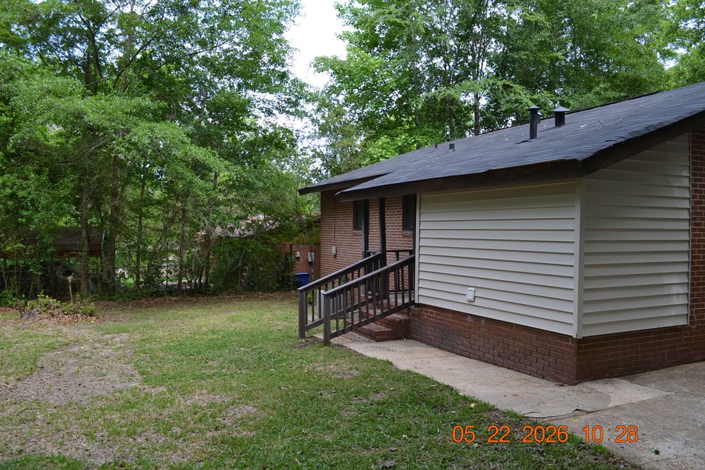 5552 Valleybrook Road Columbus, GA 31907 - Photo 24 of 27 a backyard of a house with wooden fence and large trees