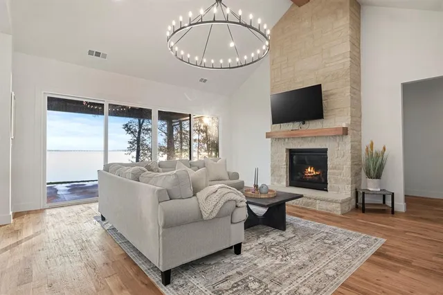 a living room with furniture a rug and a fireplace