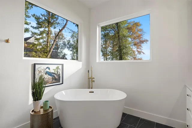 a white bath tub sitting next to a white sink